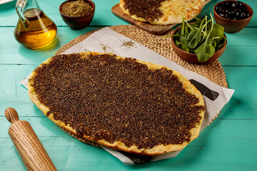 Zataar Mashrooha pizza served in dish isolated on wooden table side view of middle eastern food
