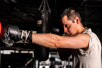 High quality photography. Caucasian man in profile with arm outstretched throwing a punch while...