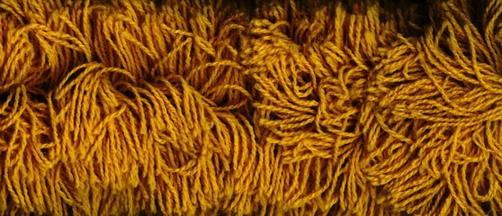 a yellow string background in the form of a pattern composed of numerous tangled, slightly fluffy...