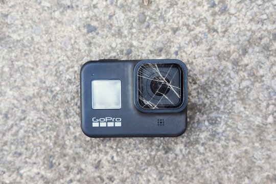 london uk, 23.04.2021 A go pro hero 8, 4k action sport digital video recorder with a cracked glass lens screen on a cold hard concrete and cement floor. Action sport rugged action  cameras.