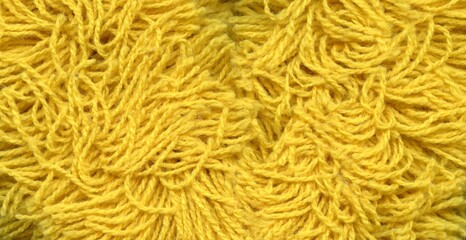 a yellow string background in the form of a pattern composed of numerous tangled, slightly fluffy strings - obrazy, fototapety, plakaty