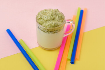 Naklejka premium Whipped green tea with milk, dalgona matcha latte in glass. Selective focus.