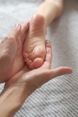 Masseur hands gives foot massage to a child. Sensual touching 
