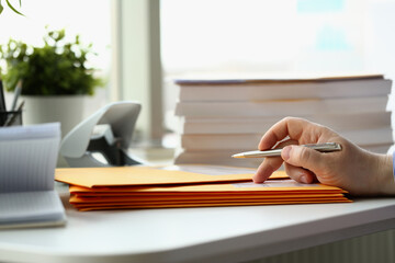 Person fill in the address on yellow envelope of postal correspondence