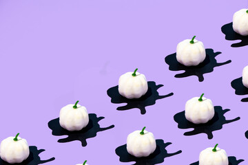 Creative layout of a white pumpkin with black blood on a lilac background. Minimal, fashion, surreal idea, holiday trendy concept for Halloween.