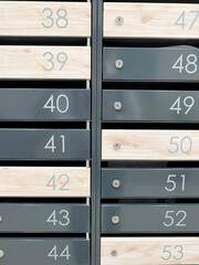 Metal mailboxes with numbers. Apartment numbers on mailboxes. Vertical photo