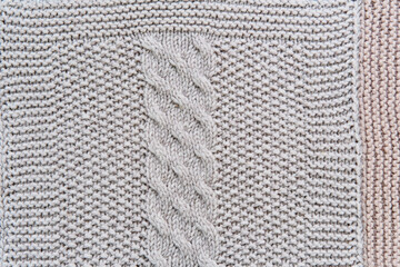 Knitted pattern of gray wool in form of close-up vertical harness