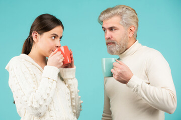 Friends drinking tea on blue background. Couple drinking tea. Morning cup, coffee mug, people on isolated background with copy space.