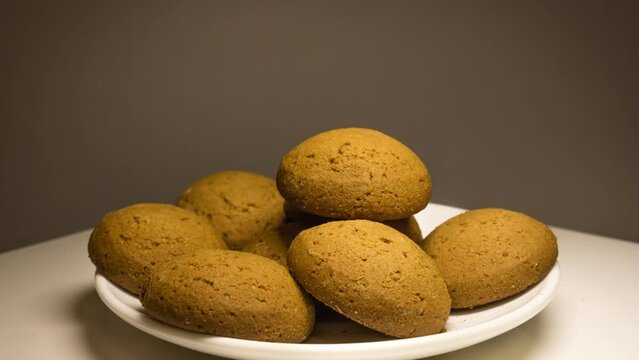 Plate full of tasty oatmeal cookies quickly becomes empty. Appetizing stop motion video