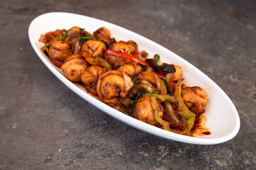 fried dumplings in a white plate on a gray background