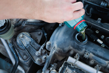 Fototapeta premium pouring engine oil into the engine