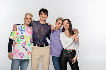 young lgbtq community friends looking at camera while embracing isolated on grey.