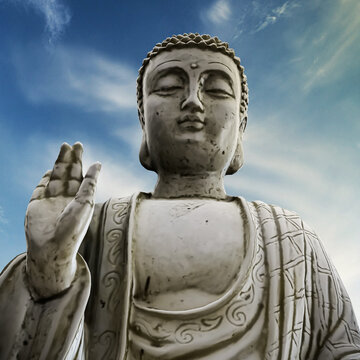 Buddha statue below a blue sky