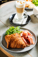 croissant with ham and coffee