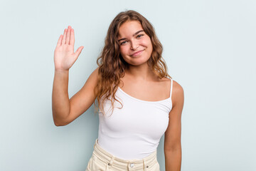 Fototapeta na wymiar Young caucasian woman isolated on blue background smiling cheerful showing number five with fingers.