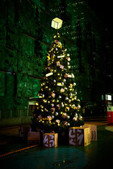 Illuminated tall Christmas tree on street decorated by Yandex Market company