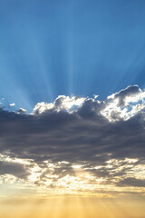 beams of sun light poking through the clouds