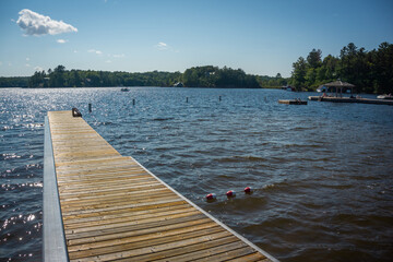 Wooden jetty with metal railing on Lake Rosseau, Muskoka, Ontario, Canada. A popular place for outdoor and water activities