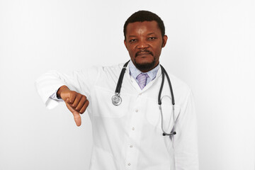 Smiling black bearded doctor man in white robe with stethoscope shows like gesture, white background