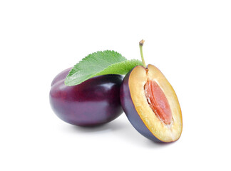 Glossy dark purple plum whole and half with leaf isolated on white background