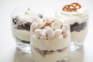 Delicious sweet dessert with cream in a glass on a light background, a beautiful breakfast