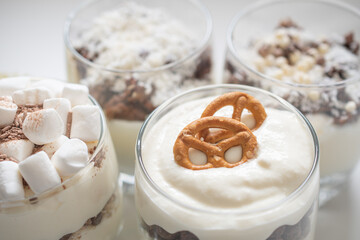 Delicious sweet dessert with cream in a glass on a light background, a beautiful breakfast