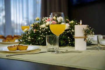 set table with glasses of orange juice on the background of the evening sky