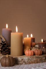 Obraz na płótnie Canvas Autumn table decoration. Interior decor for fall holidays with handmade pumpkins and candles. Holiday greeting card