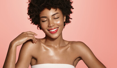 Skin care. Smiling African American beauty model, girl laughing and smiling, has shiny, clear...