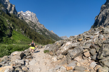 Fototapeta na wymiar Woman hiker with a backpack on the Cascade Canyon trail in Grand Teton National Park