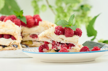 Round meringue pie with fresh raspberries on a white background, Pavlova dessert