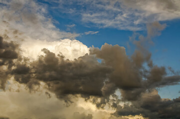 layered storm clouds, heavy rain clouds, sky before sunset spectacularly illuminated by sunlight, weather, atmospheric conditions