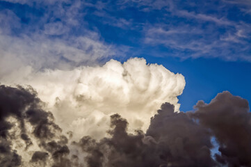 layered storm clouds, heavy rain clouds, sky before sunset spectacularly illuminated by sunlight,...