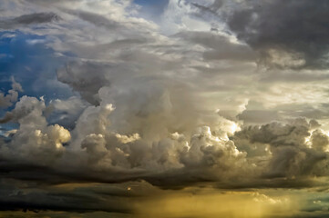 layered storm clouds, heavy rain clouds, sky before sunset spectacularly illuminated by sunlight, weather, atmospheric conditions