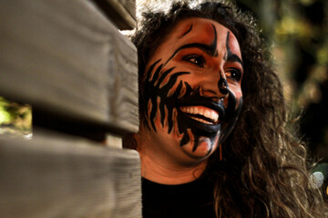 Smiling woman with halloween night makeup. Portrait of a woman with halloween night makeup outdoors