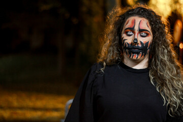 Portrait of a woman with halloween night makeup outdoors. Smiling woman with halloween night makeup