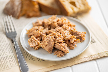 Canned tuna fish on the plate.