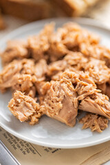 Canned tuna fish on the plate.