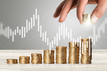 Hand putting coins for growth and investment concept
