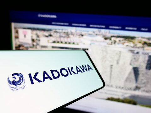 Stuttgart, Germany - 09-08-2022: Mobile phone with logo of Japanese media company Kadokawa Corporation on screen in front of business website. Focus on center of phone display.