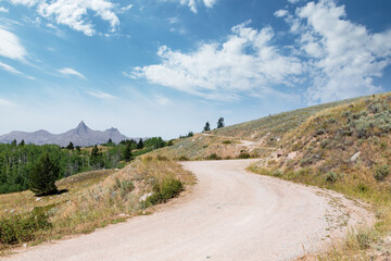 Desolate rural S curve curvy country road to camping in rural Montana near Wyoming border showing...