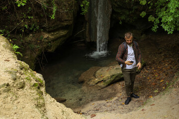 a man in the forest with a phone