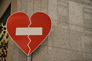 Sexist violence prohibited. Symbol against sexist violence, broken red heart.