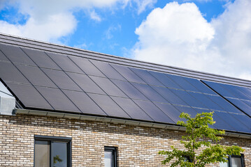 Detail of the rooftop covered with solar panels of energy efficient terraced houses