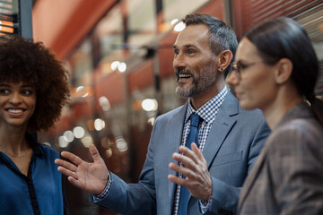 Businesspeople talking while standing in office during break. Teamwork concept