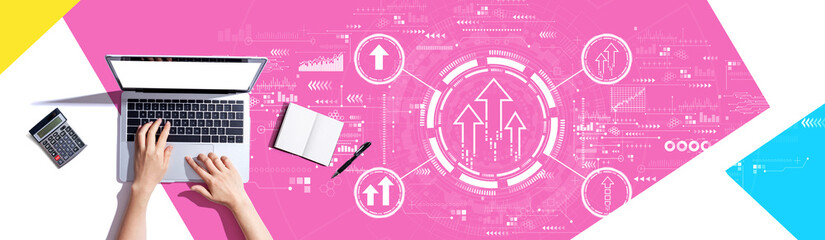 Rising arrow theme with person using a laptop computer