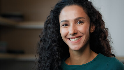 Close up headshot female portrait young sexy girl arabian hispanic student housewife beautiful gorgeous stylish woman with long curly hair perfect clear skin smiling healthy white smile beauty concept