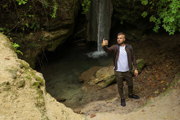 a man in the forest with a phone