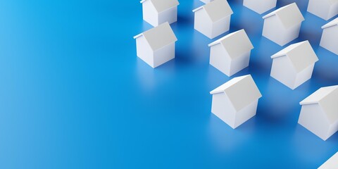 Group of small white houses on blue background with copy space, real estate or housing concept