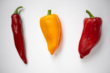 Red and yellow peppers. Three peppers.